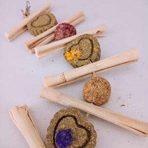 Hanging rabbit treats with calendula, timothy hay, rose, apple sticks, and bamboo